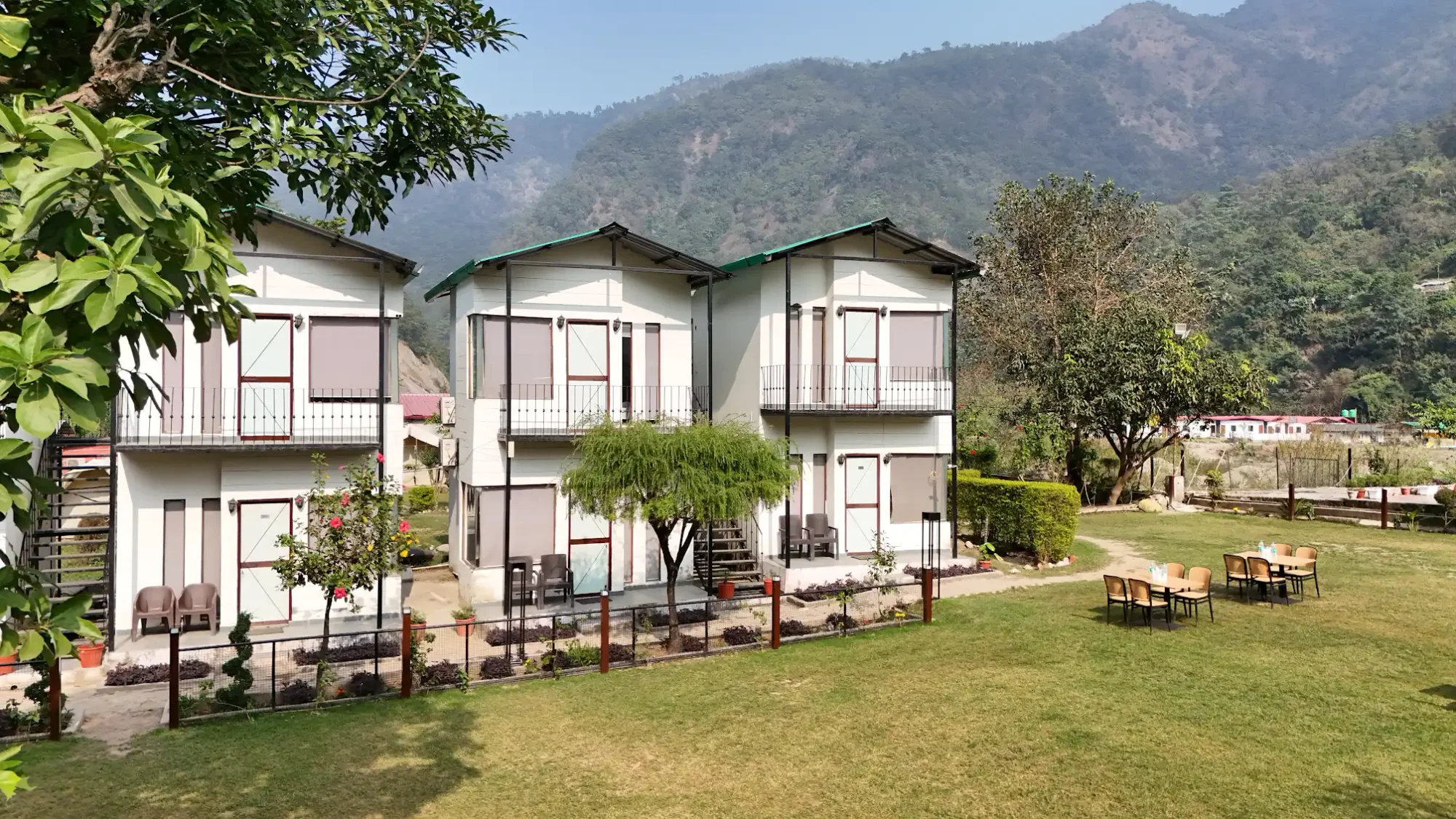 Guest cottages and lawn with hills beyond