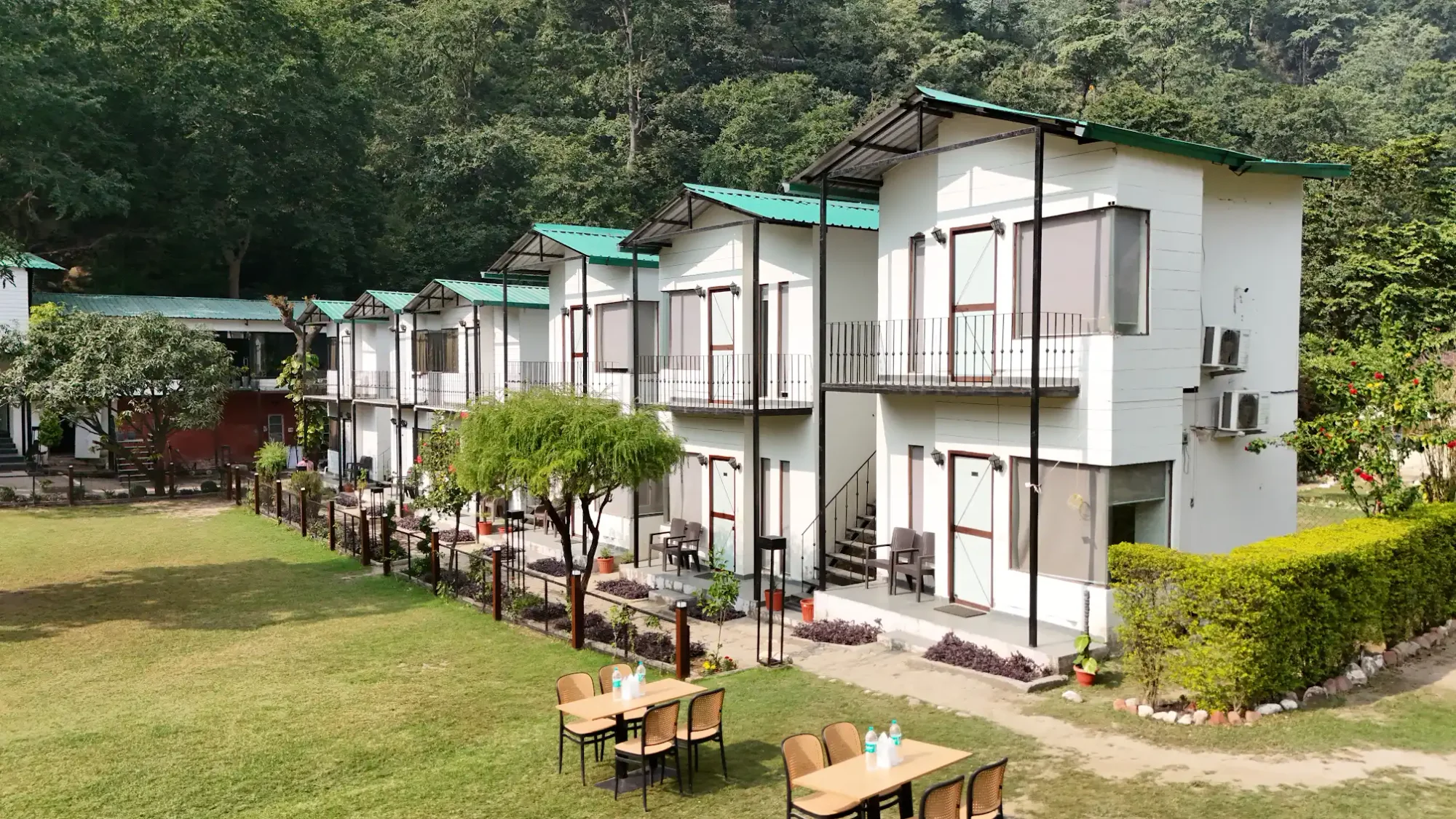 Cottages framed by trees and garden seating