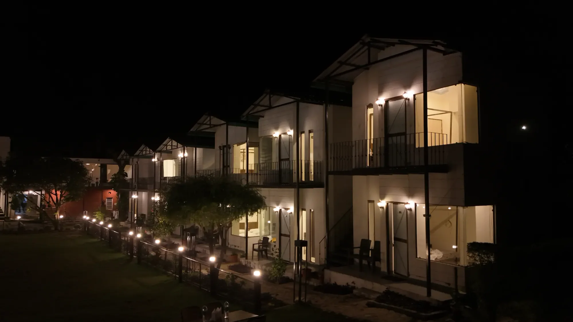 The guest cottages illuminated after dark