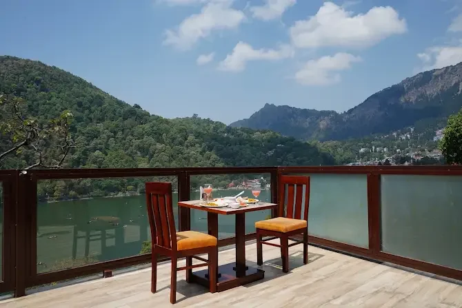 A balcony table overlooking the lake and wooded hills