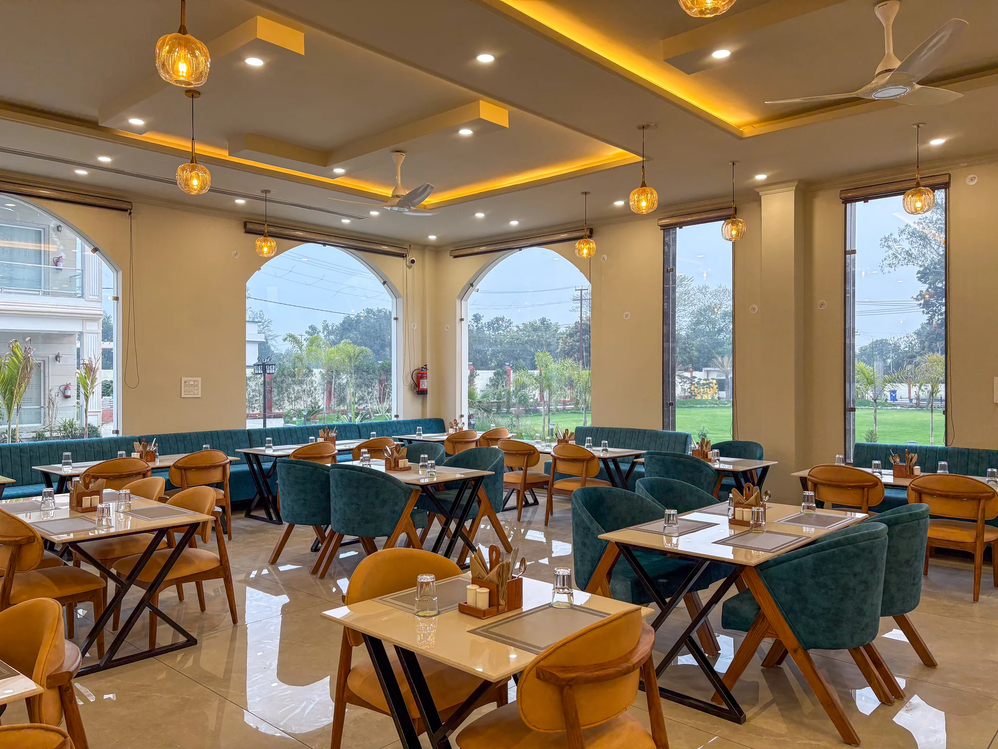 Dining room with large windows and teal chairs