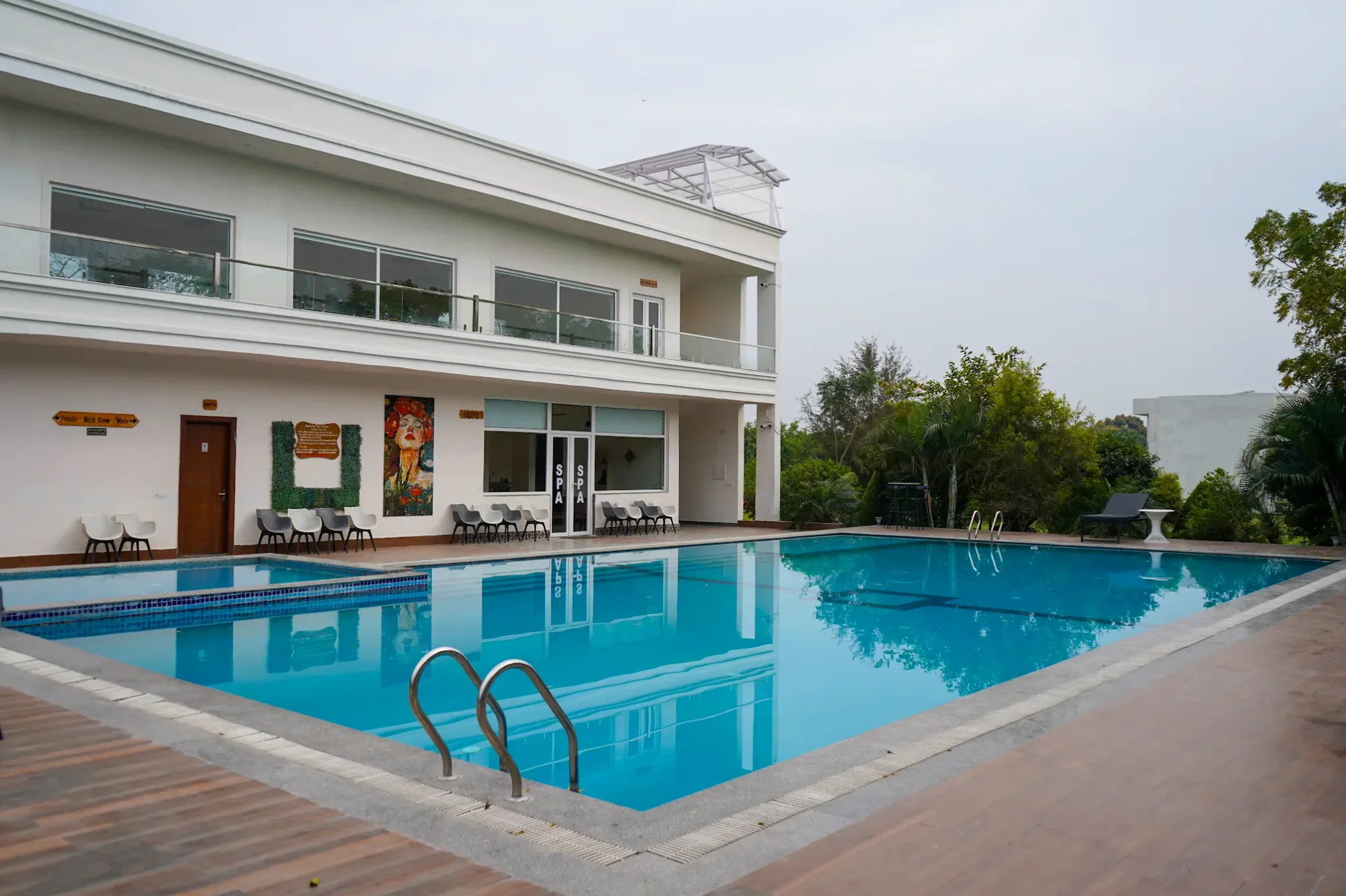 Swimming pool alongside the white guest building