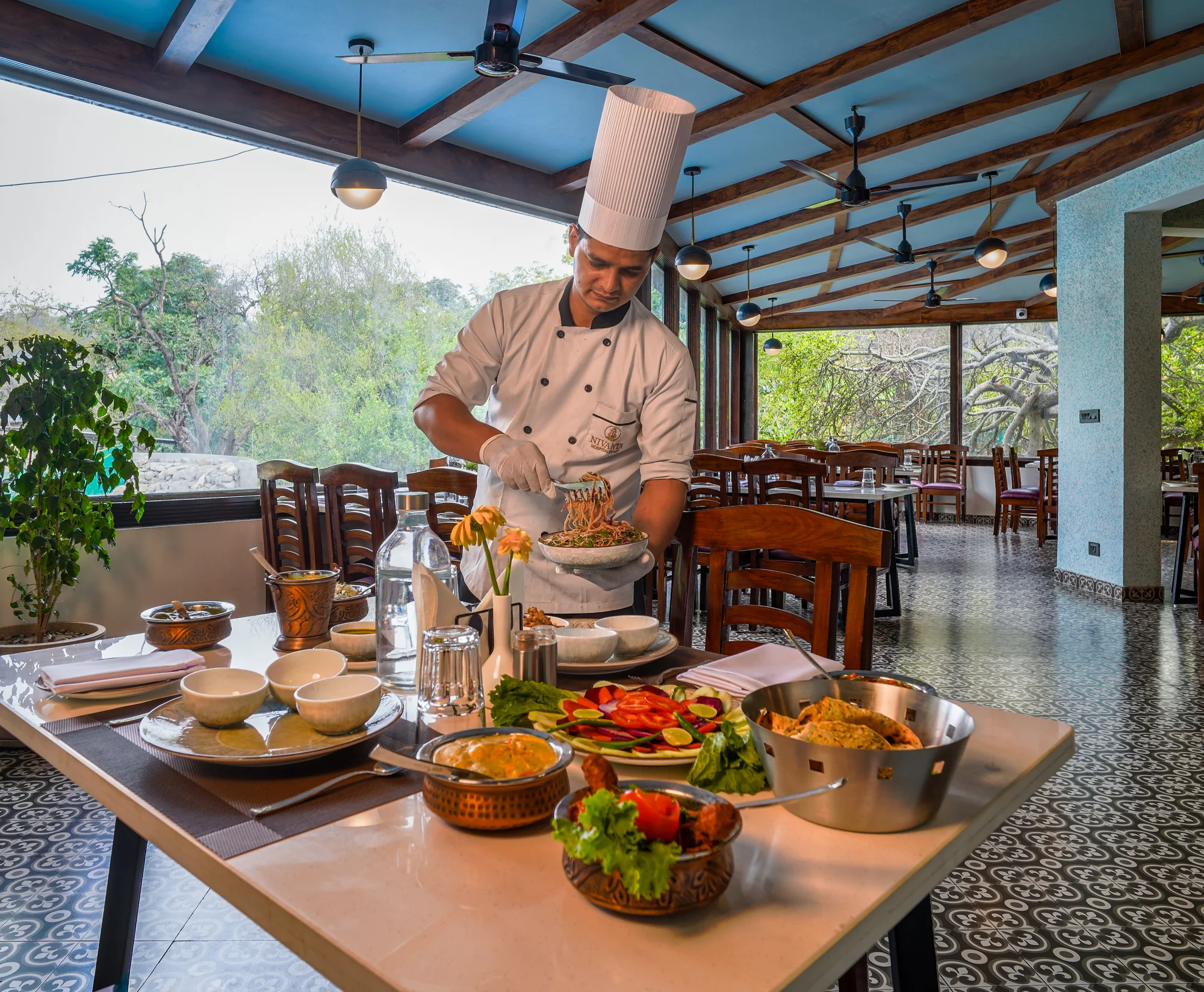 Chef preparing dishes beside the dining room windows