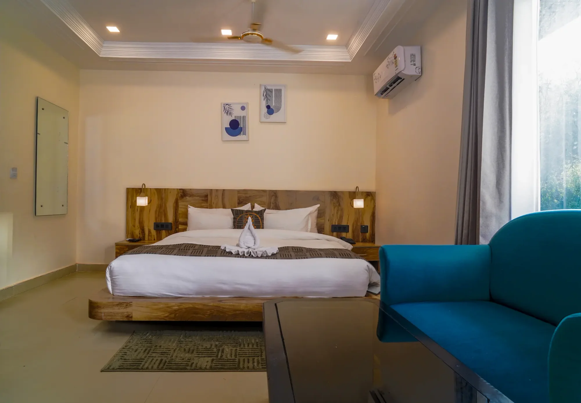 Guest bedroom with a teal armchair