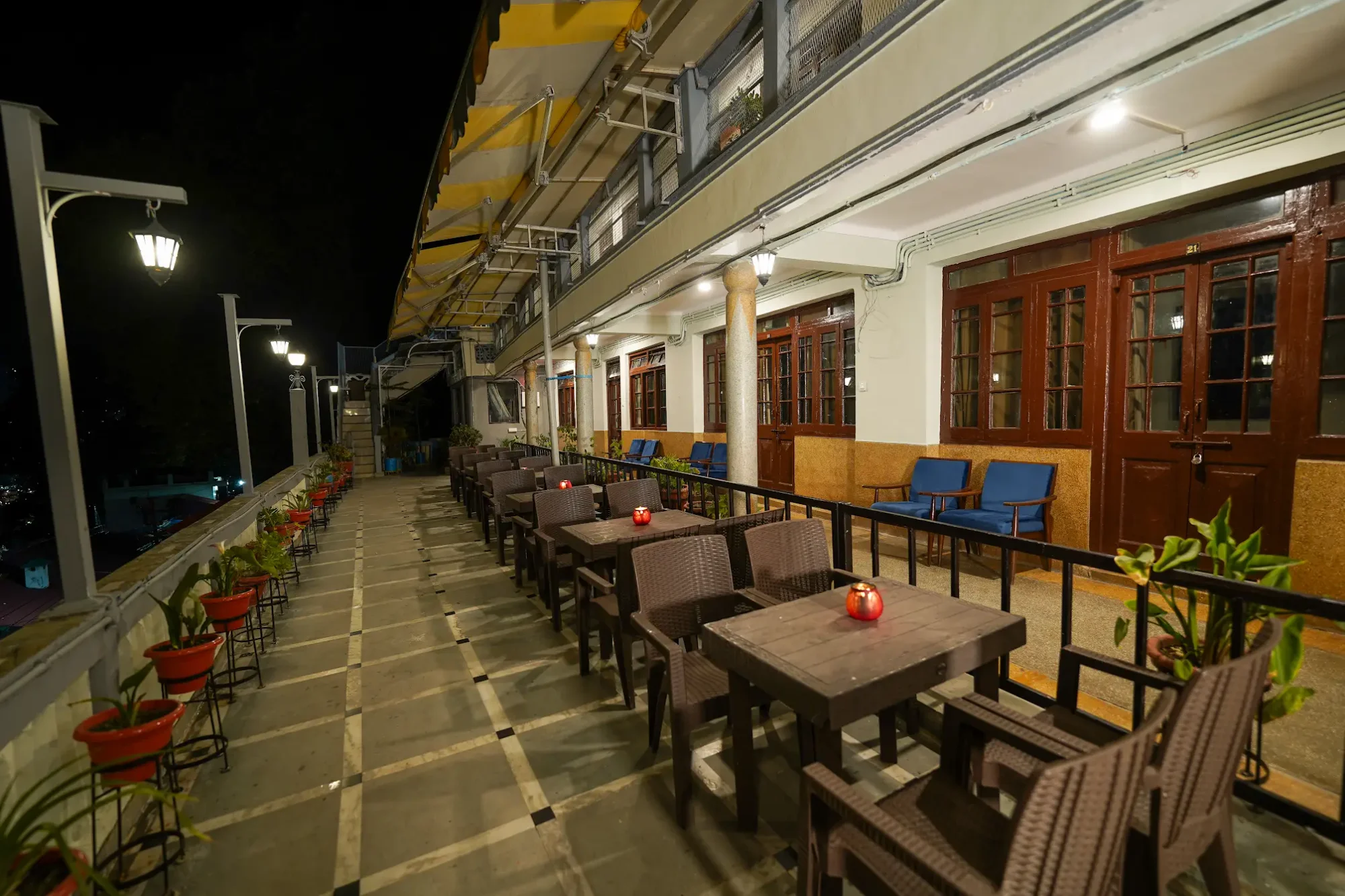 Tables along the illuminated terrace at night