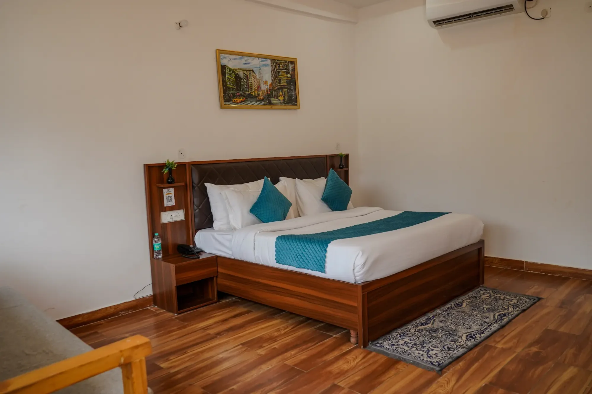 Wood-finished guest bedroom with teal cushions