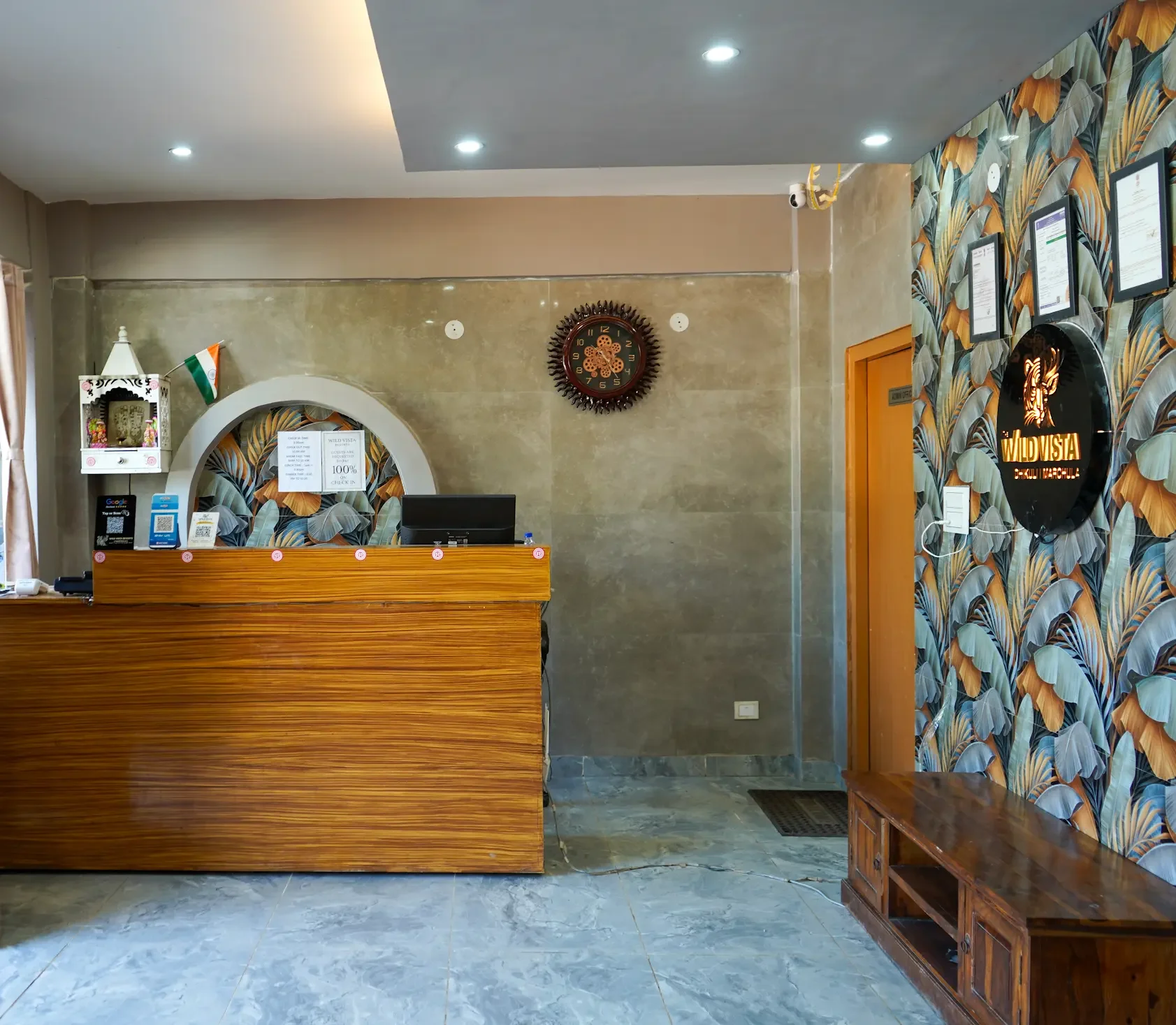 Reception desk beside a patterned feature wall